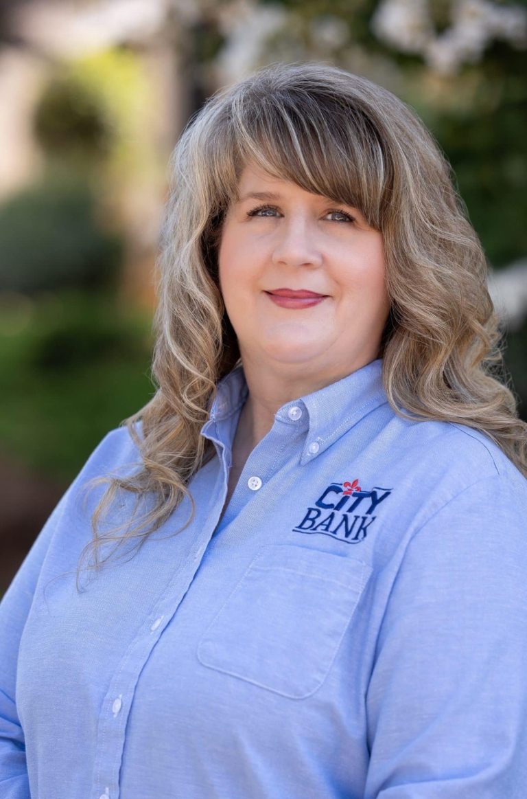 Woman with blond hair and blue collar shirt