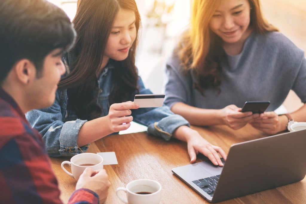 Parents and teen making a payment online using the Next Gen Checking account card
